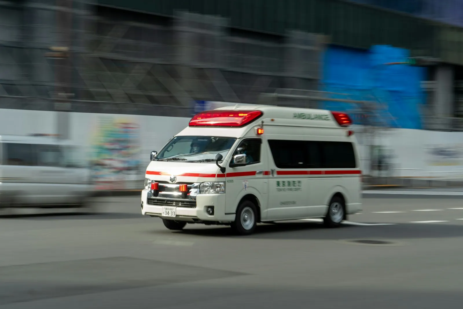 Ambulance with emergency lights on driving along a road to answer an emergency call