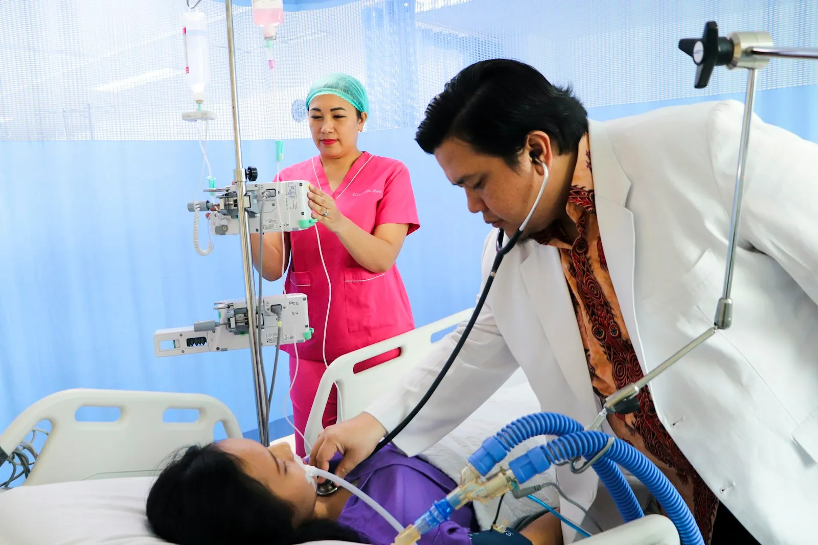 Doctor and nurse providing emergency care to a patient in a hospital treatment area