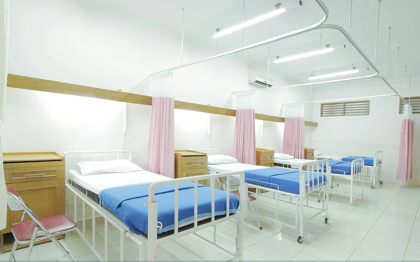 Clean hospital ward with neatly made beds ready for inpatient care